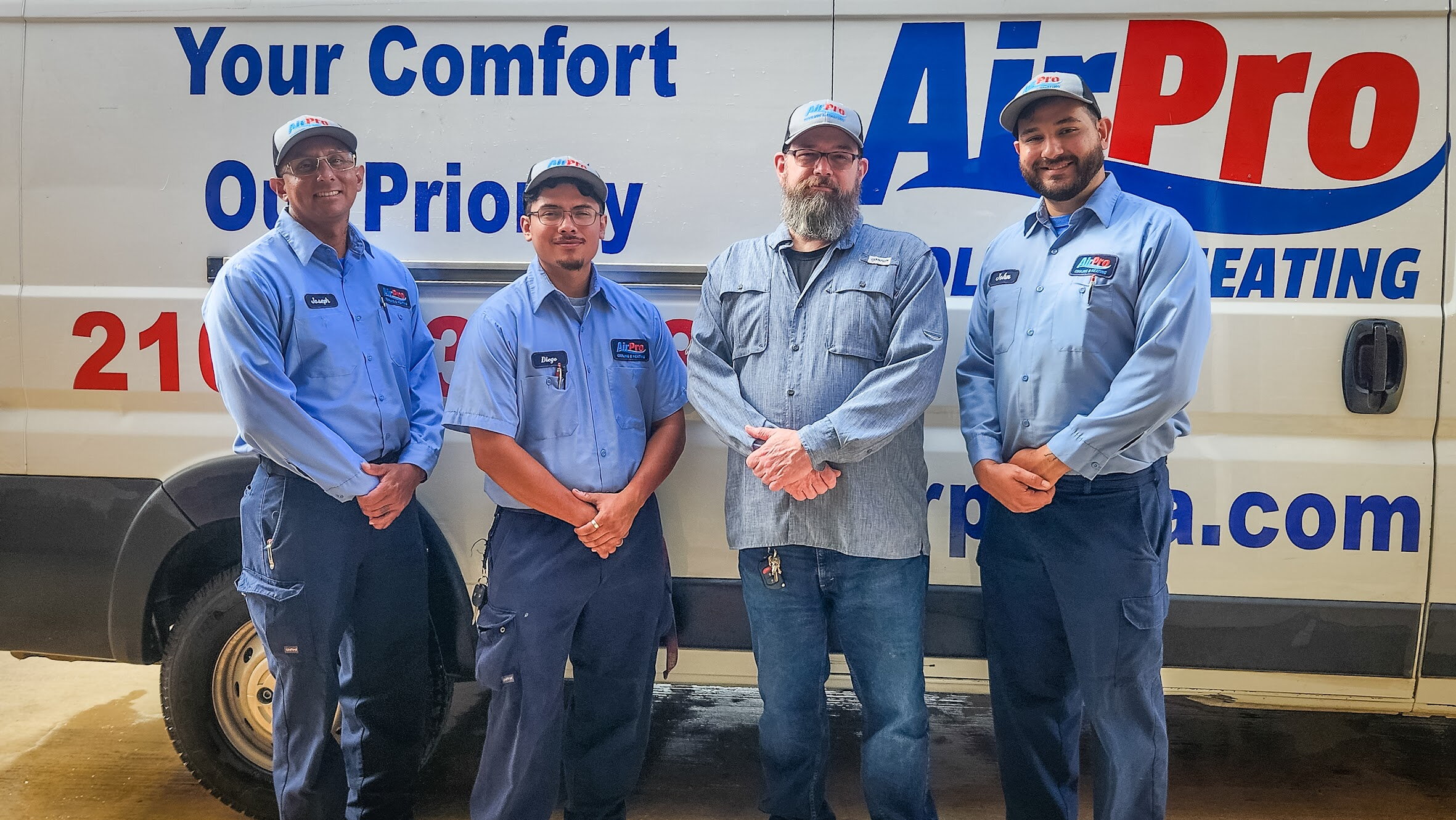 AirPro Cooling & Heating technicians in front of branded service truck