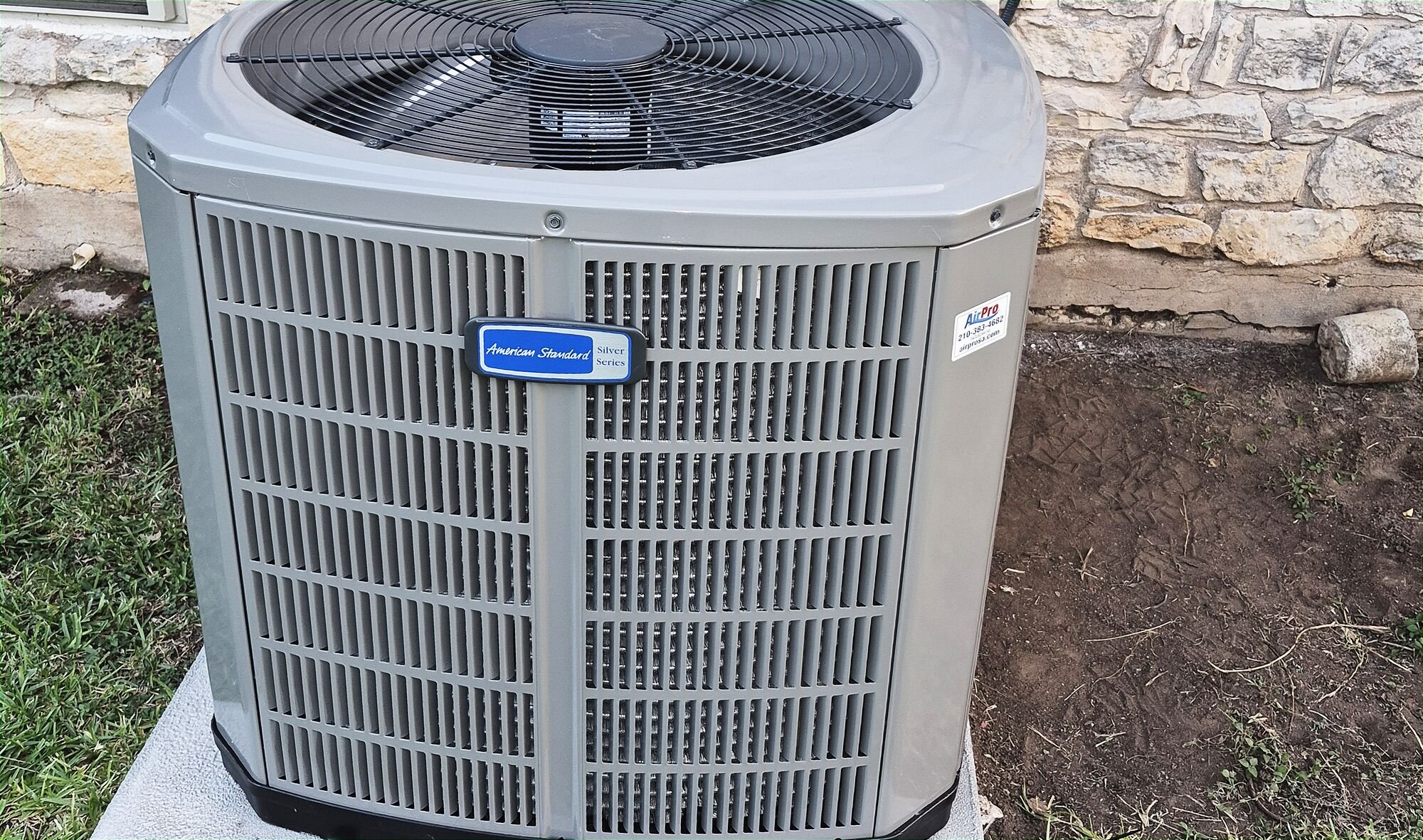 A newly installed American Standard AC condenser outside a San Antonio home