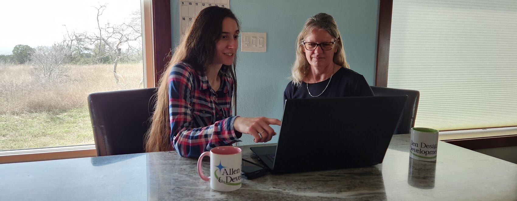 Brianna Allen sitting down with a local business owner to plan their website