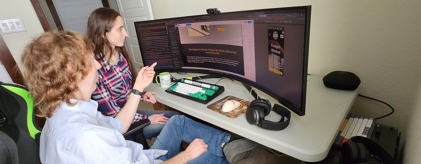 Preston and Brianna Allen building custom software on a wide monitor in Bandera, Texas