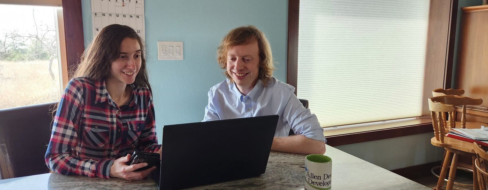 Preston and Brianna Allen working together at their kitchen table in Bandera, Texas