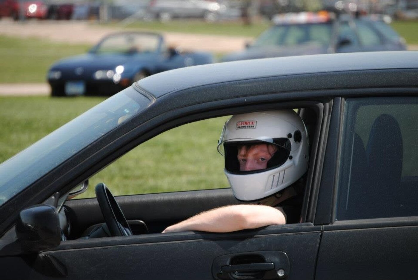 Preston Allen in his autocross car wearing a racing helmet