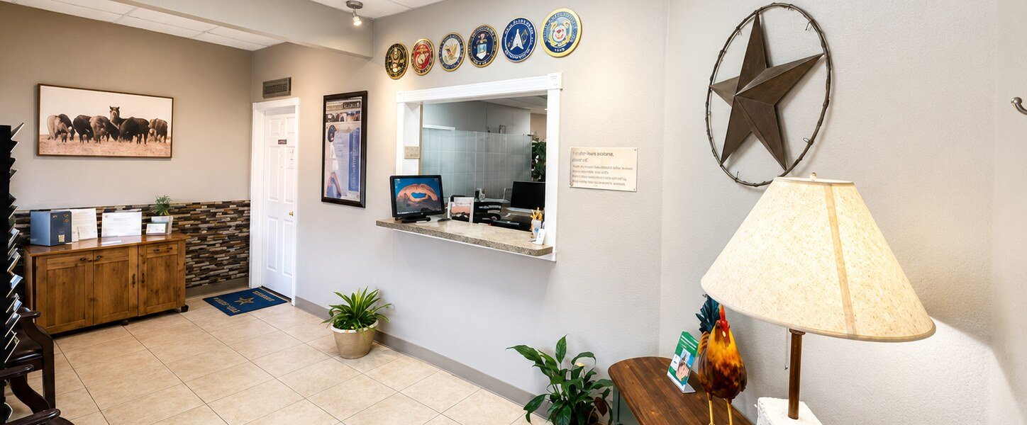 The waiting room at Bandera Chiropractic, with the front desk, a Texas star and the US military service seals on the wall