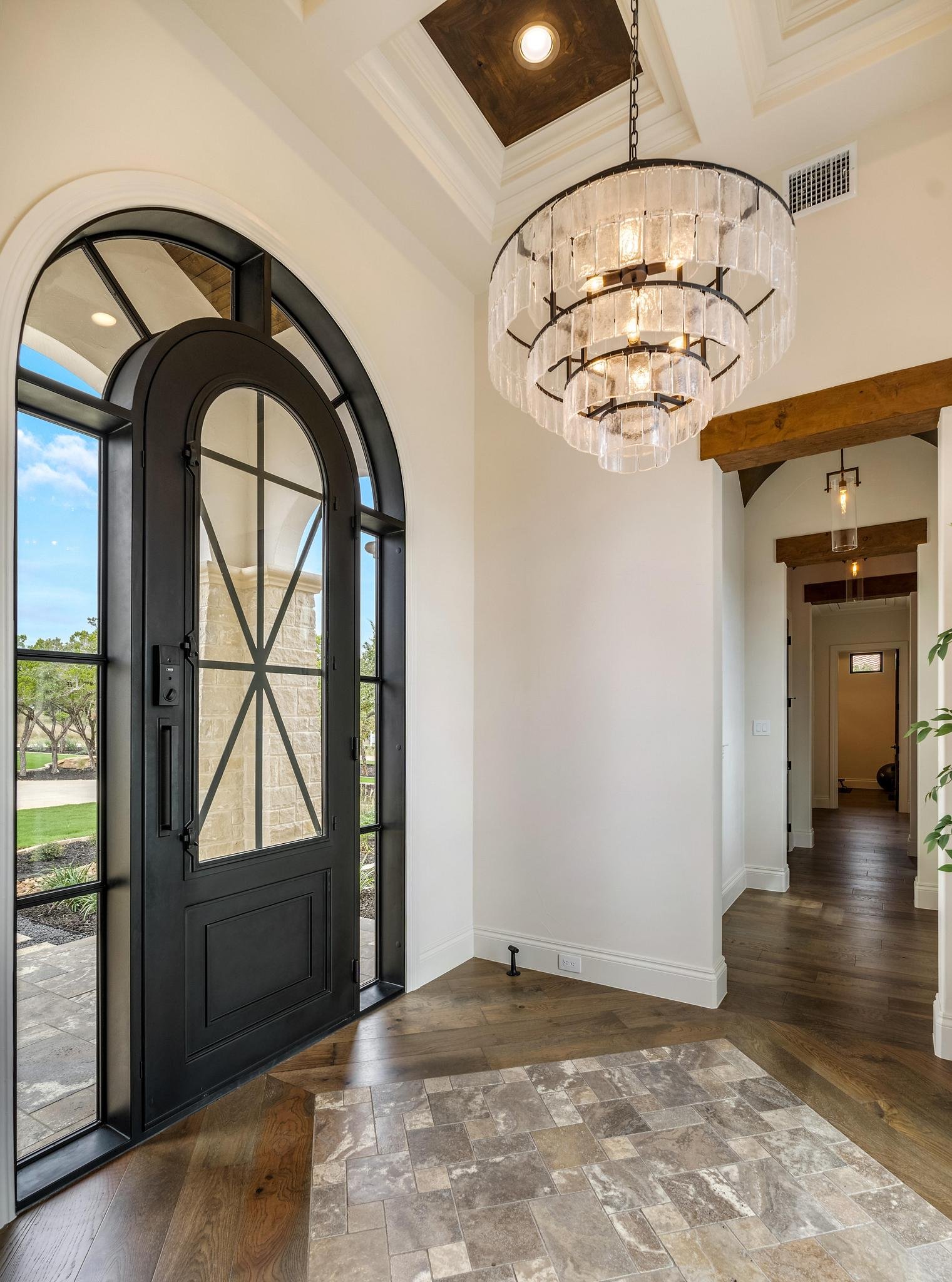 The arched iron entryway of a Marquis Builders custom home in Pecan Springs