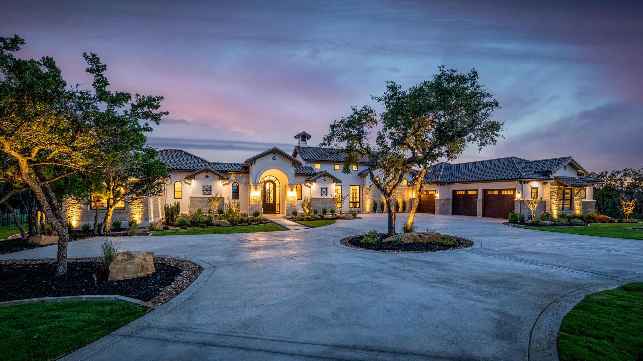 A Marquis Builders custom home at twilight in the Texas Hill Country