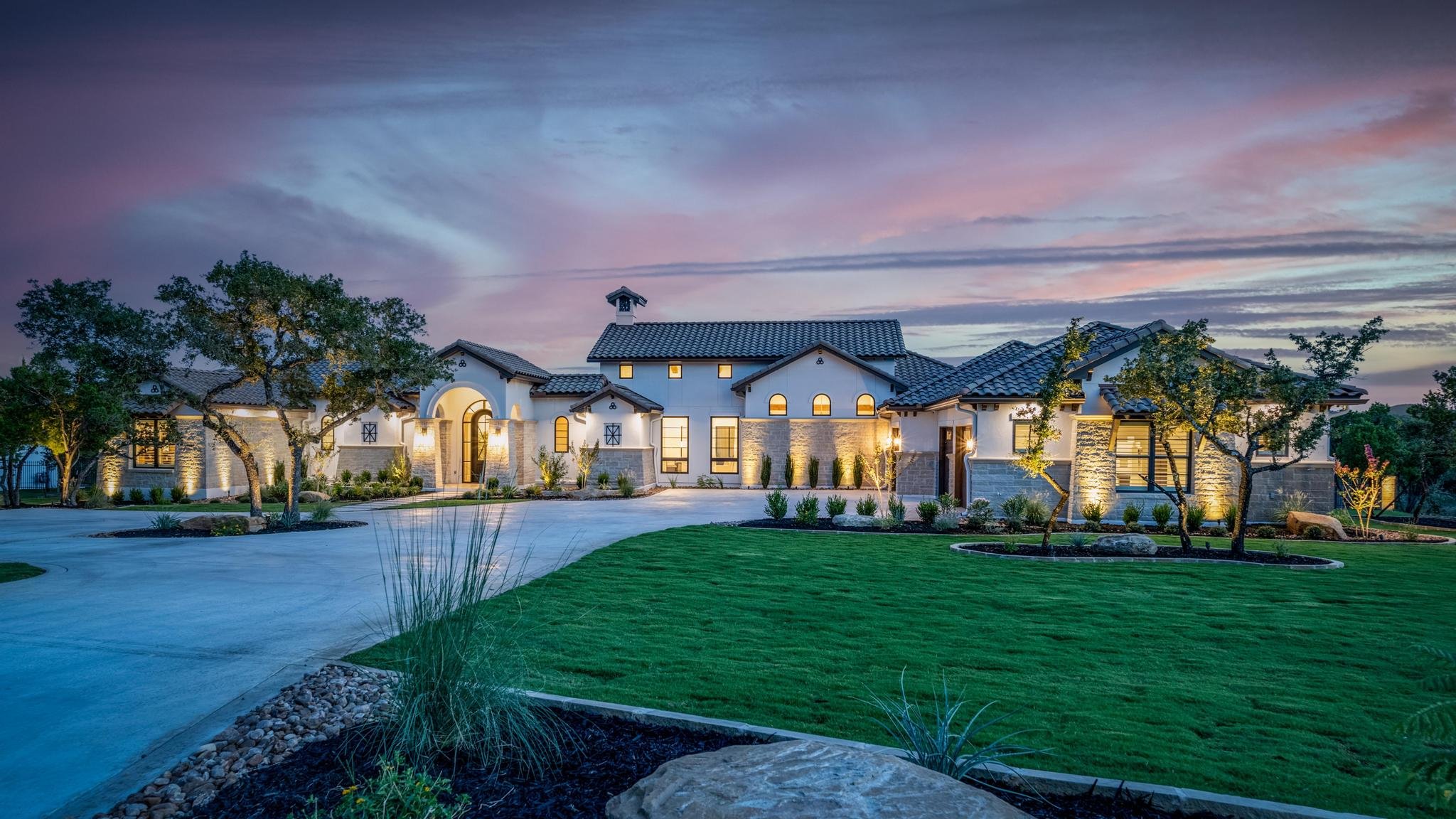 Marquis Builders Pecan Springs custom home at twilight, exterior front elevation