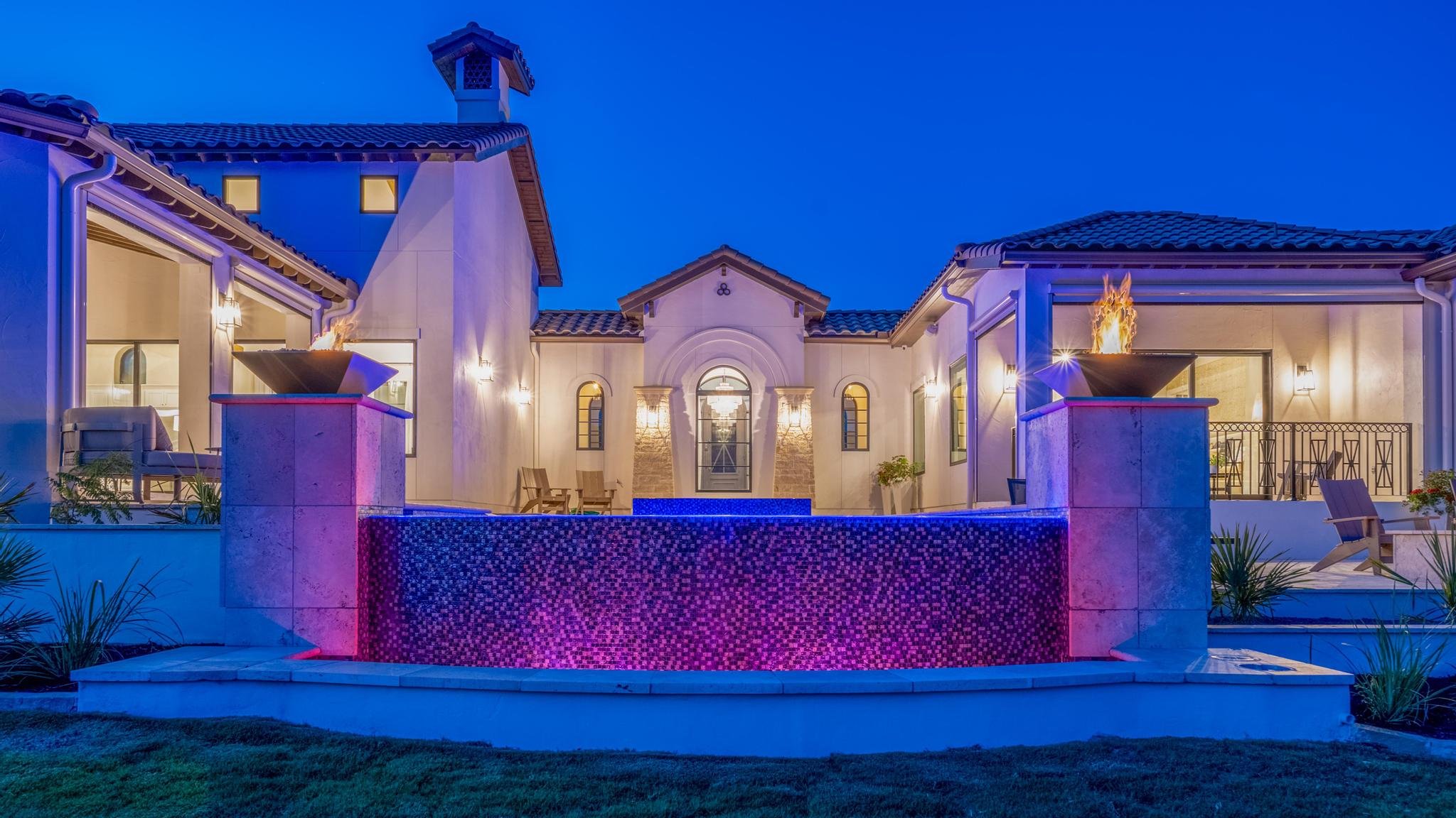 A Marquis Builders custom home at twilight, wide exterior