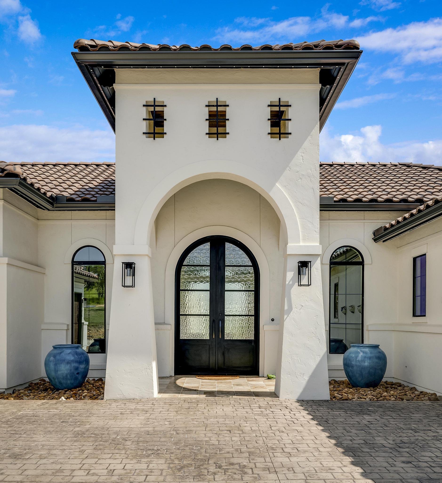 A Marquis Builders custom home at twilight in the Texas Hill Country