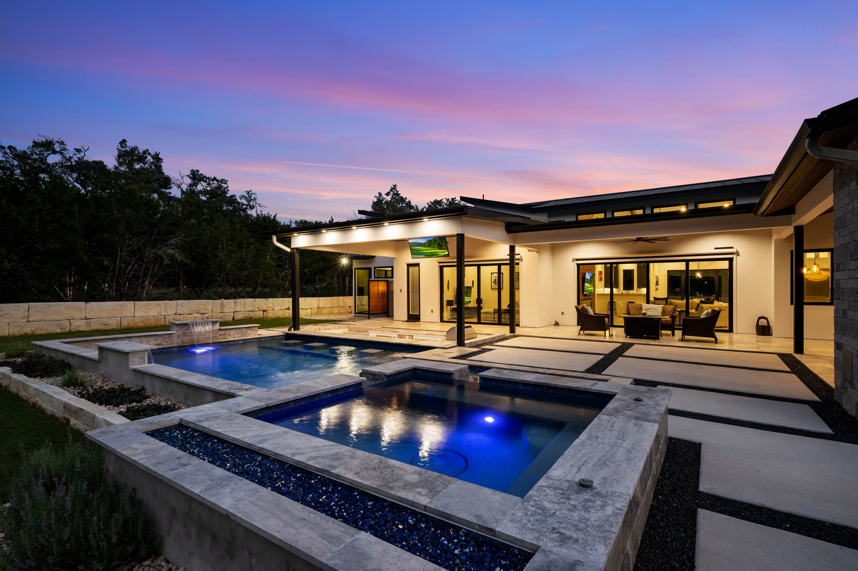 A Marquis Builders custom home at twilight in the Texas Hill Country