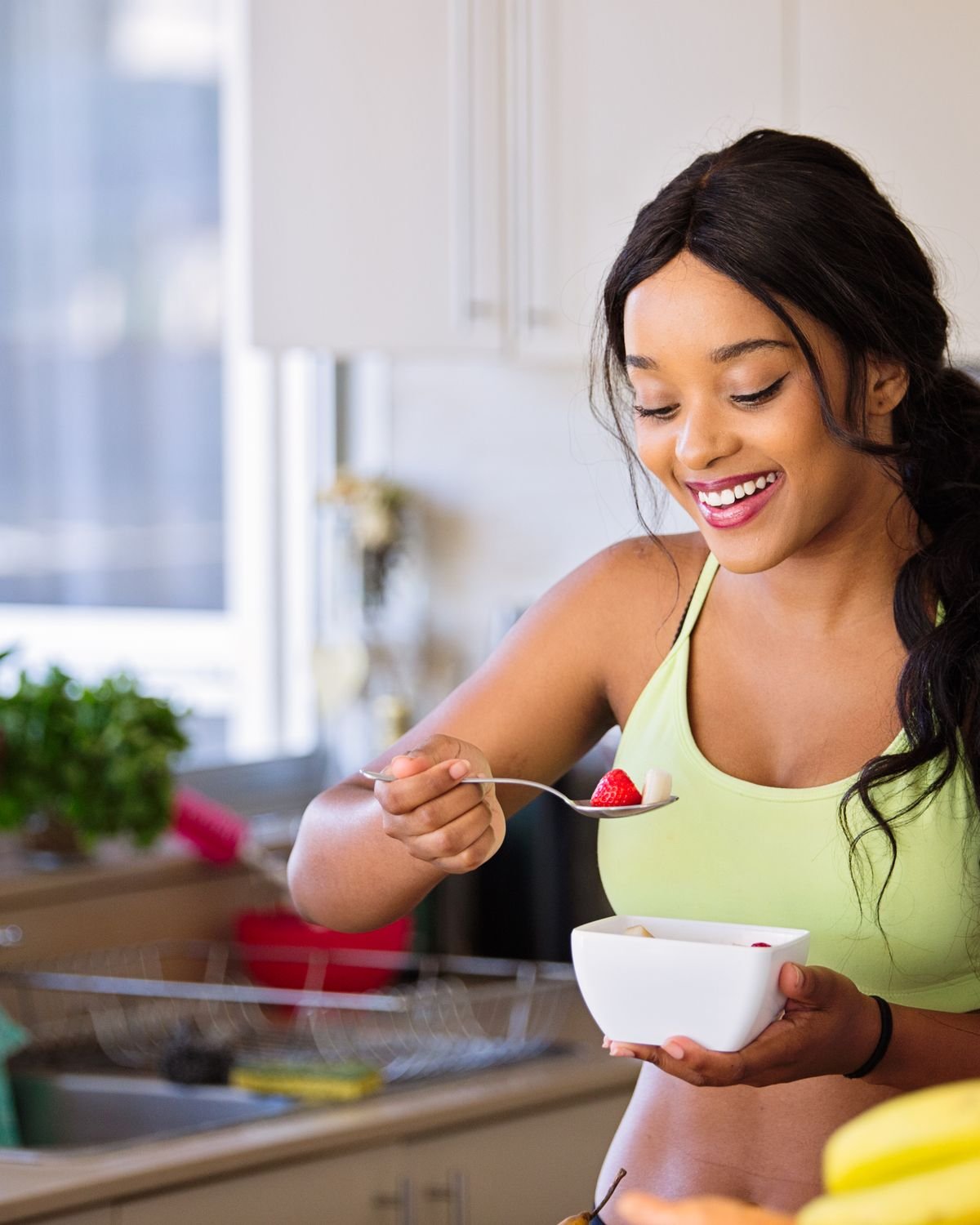 A woman enjoying a healthy meal at home