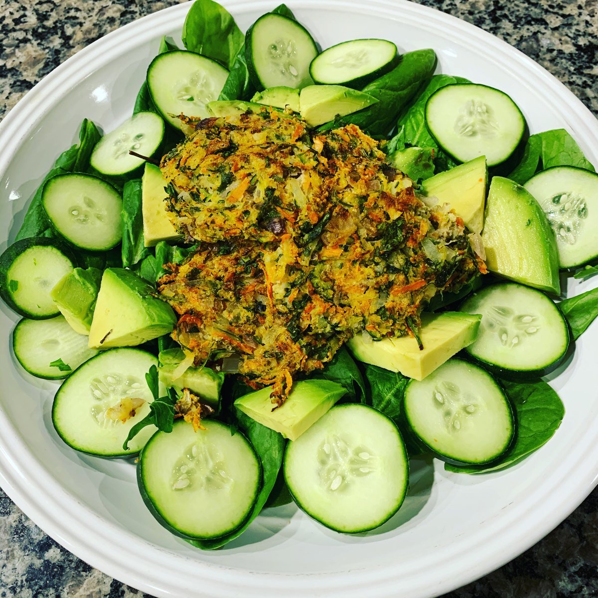 A fresh plated meal of spinach, cucumber, and avocado for the Microbiome Diet